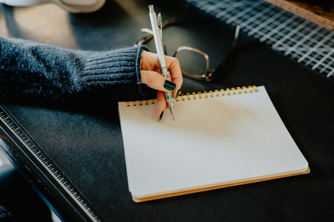 person journaling at desk