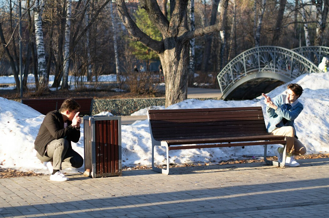 Two people in a warm conversation on an outdoor bench