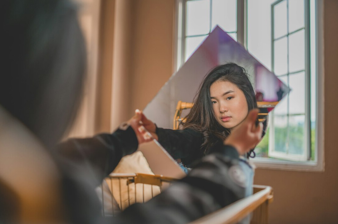 woman practicing speech in mirror